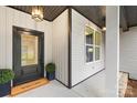 Inviting front porch with a dark front door and a 'Welcome' mat at 5147 Star Magnolia Ct, Clover, SC 29710