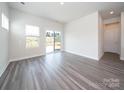 Open living room with gray flooring and large sliding door at 5208 Georgette Trl, Cherryville, NC 28021