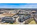 Wide aerial view of townhome community nestled among retail and other housing, under a sunny sky at 5472 Ives Nw St, Concord, NC 28027