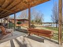 Inviting back patio with wood ceiling, comfortable seating and serene lake views perfect for outdoor relaxation at 5981 Johnson Rd, Lake Wylie, SC 29710