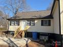 View of the rear exterior, showcasing the newly constructed wooden staircase at 622 Watts St, Albemarle, NC 28001