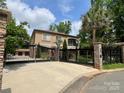 Beautiful two-story home featuring a gated entrance, lush landscaping, and a well-maintained yard at 8104 Stem Ct, Charlotte, NC 28227