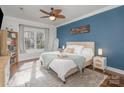 Cozy bedroom featuring hardwood floors, a large window and an accent wall at 8433 Delberry Ln, Charlotte, NC 28277