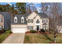 Classic two-story home featuring dormer windows, black shutters and a two car garage at 910 Elrond Nw Dr, Charlotte, NC 28269