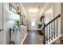 Inviting home entryway features hardwood floors, a decorative console table, and staircase at 1024 Mayapple Way, Belmont, NC 28012
