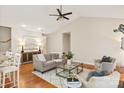 Spacious living area with modern decor, hardwood floors, a ceiling fan, and a comfortable seating arrangement at 1055 Curry Way, Matthews, NC 28104