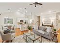 Sunlit living room boasts an open layout, hardwood floors, and stylish furnishings creating an inviting atmosphere at 1055 Curry Way, Matthews, NC 28104