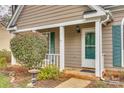 Inviting front porch with beautiful landscaping, offering a cozy space to relax and enjoy the outdoors at 106 Aurora Ln # 31, Huntersville, NC 28078