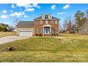 Traditional two-story brick home with attached garage and well-manicured lawn at 109 Putney Ct, Salisbury, NC 28147
