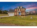 Lovely brick home featuring an attached garage and a spacious front yard at 109 Putney Ct, Salisbury, NC 28147