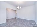 Bright dining area with hardwood floors, modern lighting and neutral paint at 111 Megby Trl, Statesville, NC 28677