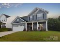 Beautiful blue home with a two-car garage and classic white trim at 111 Megby Trl, Statesville, NC 28677