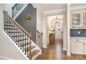 Elegant foyer featuring hardwood floors, staircase with iron railings, and stylish lighting at 114 Tomahawk Dr, Mooresville, NC 28117