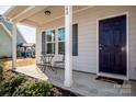 Covered front porch with seating and a view of the entrance to the residence at 140 Jana Dr, Statesville, NC 28677