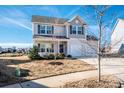 Two-story home with landscaped yard on a sunny day in a Gathering neighborhood at 140 Jana Dr, Statesville, NC 28677