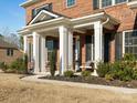 Inviting front porch with stately columns, seating, and professionally landscaped surroundings at 3078 Montreaux Valley Dr, Fort Mill, SC 29707