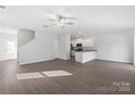 Spacious living room with hardwood floors and neutral decor that seamlessly flows into a modern kitchen at 3267 Maple Ridge Dr, Gastonia, NC 28052