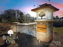 Stone pillar entrance with Bethesda Oaks sign surrounded by manicured landscaping at 3427 Laurel Oak Ln, Gastonia, NC 28056
