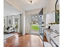 Welcoming foyer featuring hardwood floors, glass front door and sidelights and an adjacent living space at 4132 Sulkirk Rd, Charlotte, NC 28210