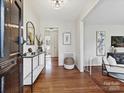 Bright entryway featuring hardwood floors, a console table, and a view into the rest of the home at 4132 Sulkirk Rd, Charlotte, NC 28210