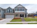 Two-story home with a brick and stone facade, featuring a two-car garage, landscaped front yard, and welcoming entrance at 4229 Steel Way, Sherrills Ford, NC 28673