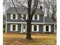 Traditional home featuring neutral siding, white trim, and a prominent tree in the front yard at 4922 Rivergreen Ln, Charlotte, NC 28227