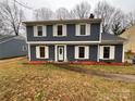 Well-maintained home with gray siding, white shutters, and landscaping at 4922 Rivergreen Ln, Charlotte, NC 28227