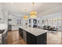 Spacious kitchen with marble island, stainless appliances, breakfast bar, and hardwood floors at 5026 Ohm Ln, Charlotte, NC 28270