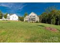 Well-manicured lawn and landscaped yard surrounding this beautiful two-story house with inviting curb appeal at 5051 Oxbow Run Ln, York, SC 29710