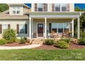Inviting front porch with rocking chairs and decorative touches, adding to the home's charm and curb appeal at 5051 Oxbow Run Ln, York, SC 29710