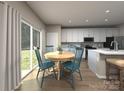 Bright dining area features wood floors, a modern table set, and sliding glass doors to the backyard at 5204 Georgette Trl, Cherryville, NC 28021