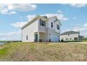 New two-story home with a two-car garage, teal door, and situated on a spacious grassy lot at 5207 Georgette Trl, Cherryville, NC 28021