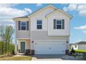 Charming two-story home featuring a white garage door, teal front door, and complementary window shutters at 5207 Georgette Trl, Cherryville, NC 28021