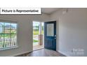 Entryway featuring hardwood floors, decorative door, and a bright window at 7771 Woolsey Dr, Gastonia, NC 28056