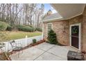 Inviting patio area with brickwork, a small tree, and a comfortable chair at 8107 Sultana Cir, Charlotte, NC 28227