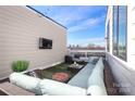 Comfortable roof deck featuring cozy seating, outdoor lighting and an integrated firepit at 932 Cityscape Dr, Charlotte, NC 28205