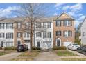 View of townhomes with brick and vinyl siding and well-maintained landscaping at 932 Tiger Ln, Charlotte, NC 28262