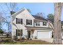 Beautiful two-story home with white siding, black shutters, and a well-maintained lawn with garden beds at 1016 Helms Rd, Charlotte, NC 28214