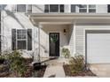 Inviting front entrance with a decorative wreath, manicured landscaping, and a well-lit porch area at 1016 Helms Rd, Charlotte, NC 28214