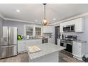 Bright kitchen featuring stainless steel appliances, granite countertops, and a center island perfect for food preparation at 106 W 16Th St, Kannapolis, NC 28081