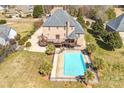 Expansive backyard with a private pool, wooden deck, mature landscaping, and fence, perfect for outdoor entertaining at 109 Dabbling Duck Cir, Mooresville, NC 28117