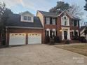 Well-maintained brick home featuring an attached two-car garage and a classic design at 1516 Plantation Trl, Gastonia, NC 28056