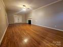 Spacious living room featuring hardwood floors, neutral walls, and a decorative fireplace at 1516 Plantation Trl, Gastonia, NC 28056