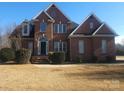 Traditional two-story brick home featuring a well-manicured lawn and a classic architectural design at 159 S Gibbs Rd, Mooresville, NC 28117