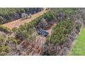 An aerial view of a beautiful brick house surrounded by lush greenery, offering privacy and a serene setting at 201 Olive Rd, Stony Point, NC 28678