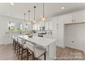 Modern kitchen with stainless steel appliances, quartz countertops, and an island with bar seating at 209 Tillery Ln # 758, Mount Gilead, NC 27306