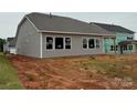 Back view of home with siding and windows. 