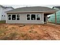 Back view of home shows siding and windows. 
