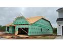Home under construction, with green sheathing, lumber framework, and visible elements indicating the building phase at 2210 Camber Dr # Cwo0075, Gastonia, NC 28054