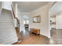 Elegant foyer featuring hardwood floors, staircase, archways, and decorative details at 2314 Talon Point Cir, Fort Mill, SC 29715